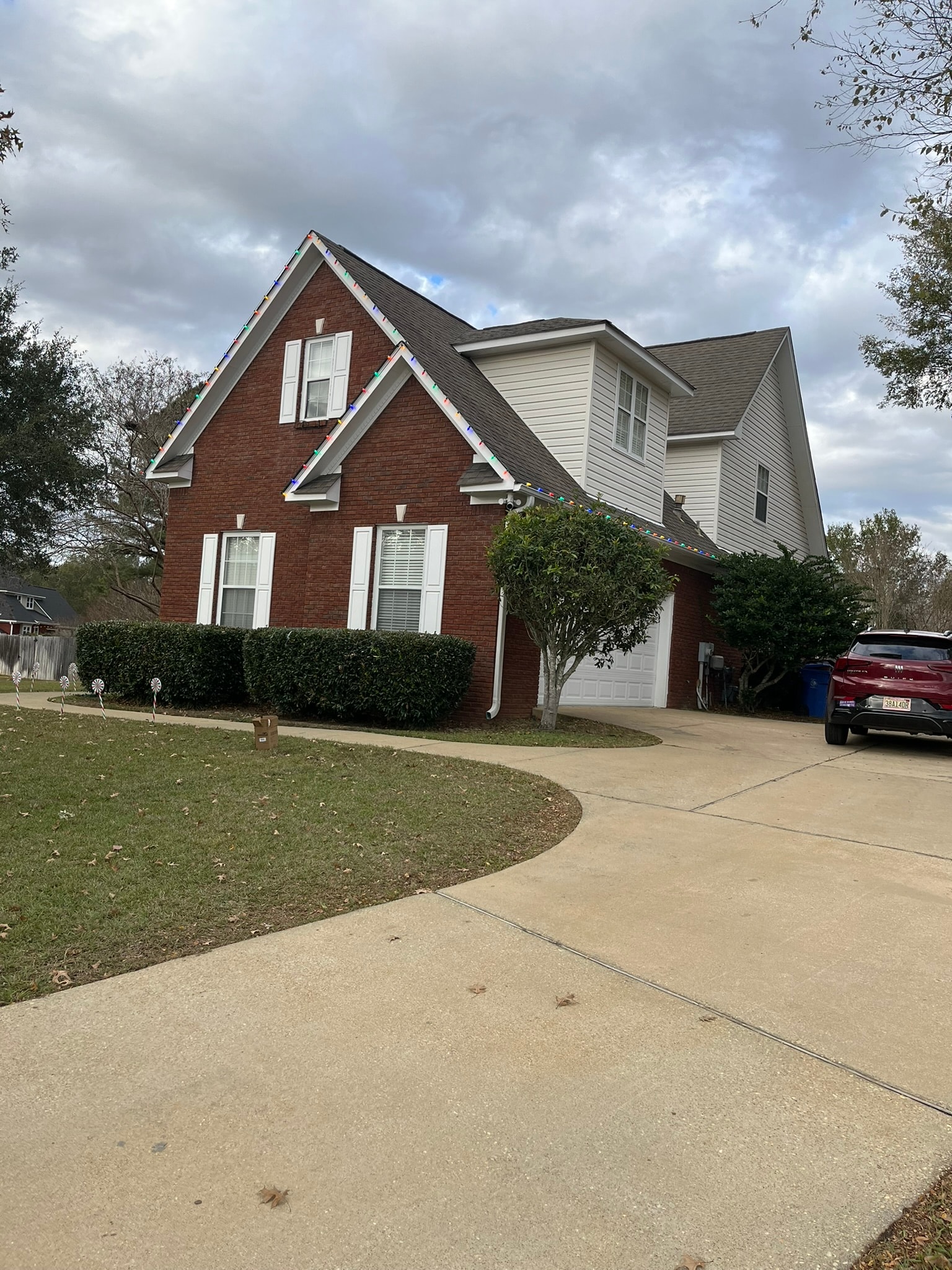 Exterior holiday lighting on brick home